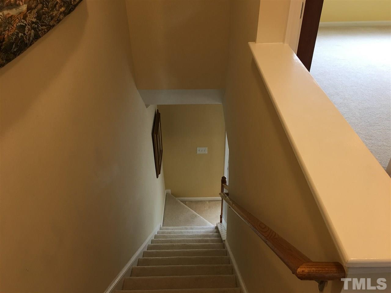 7634 Winners Edge Street Raleigh, NC 27617 - Photo 20 of 22 a view of a hallway with wooden floor and staircase