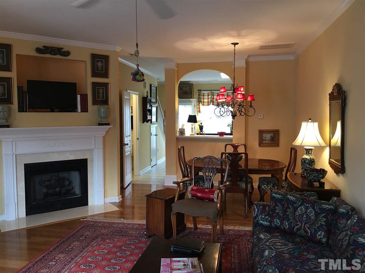 7634 Winners Edge Street Raleigh, NC 27617 - Photo 5 of 22 a view of a livingroom with furniture and a fireplace