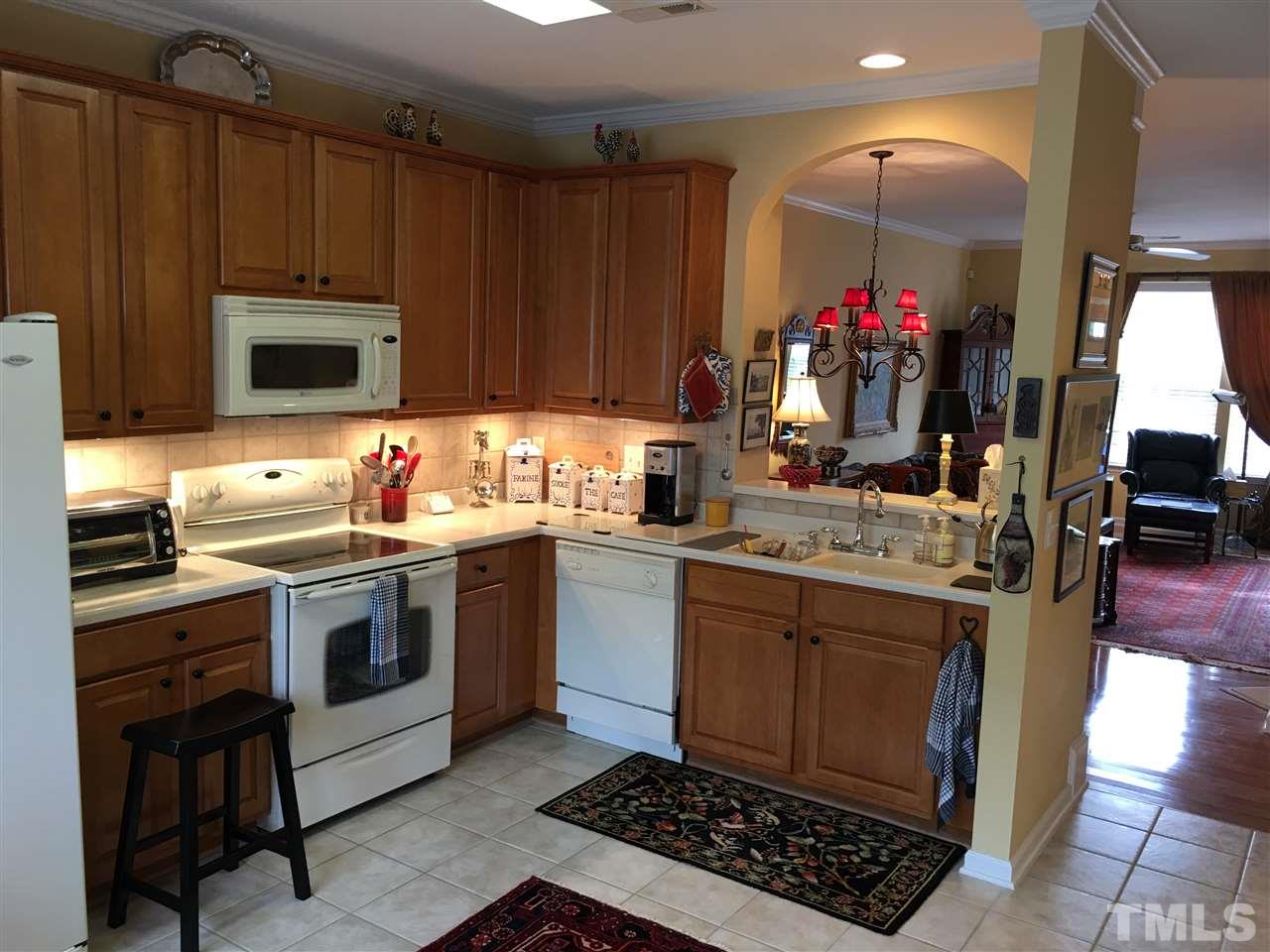 7634 Winners Edge Street Raleigh, NC 27617 - Photo 10 of 22 a kitchen with a stove and a sink