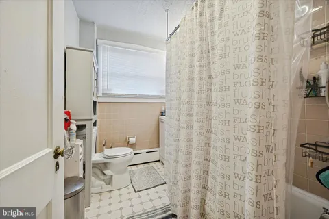 a white toilet sitting next to a bathroom sink
