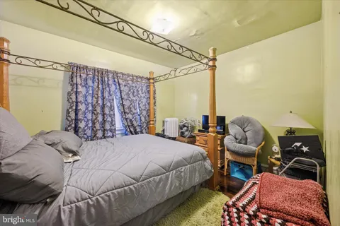 a bedroom with a bed window and walk in closet