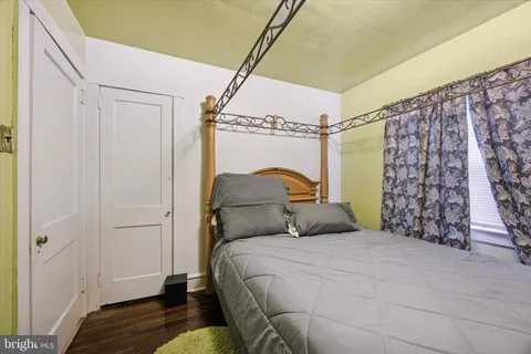 a bedroom with a bed and a mirror