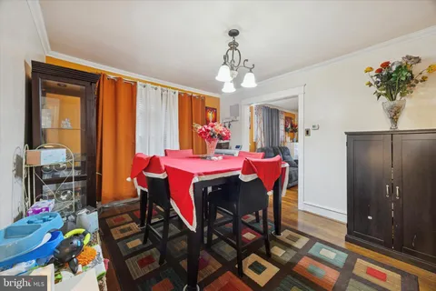 a view of a dining room with furniture and a chandelier