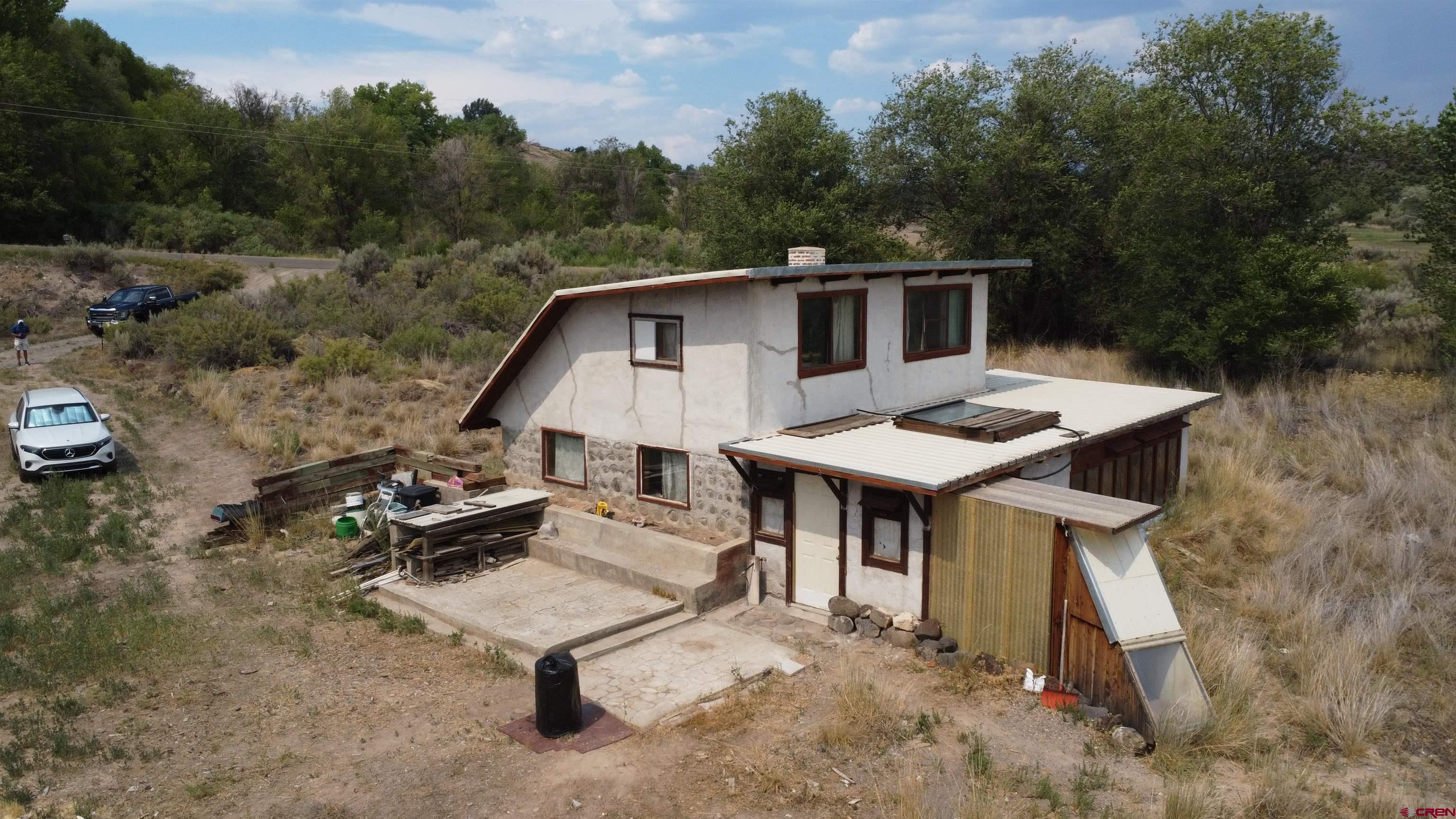 21538 Hamilton Road Eckert, CO 81418 - Photo 7 of 9 a view of a patio with table and chairs with wooden floor and fence