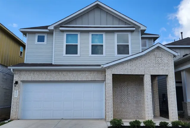 a front view of a house with garage