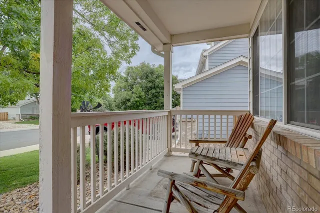 a view of a two chairs in the balcony