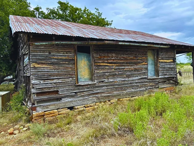 a view of a house with a yard and stairs