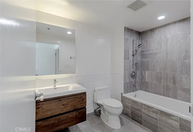 a bathroom with a sink a toilet and bathtub