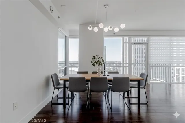 a view of a dining room with furniture wooden floor and chandelier