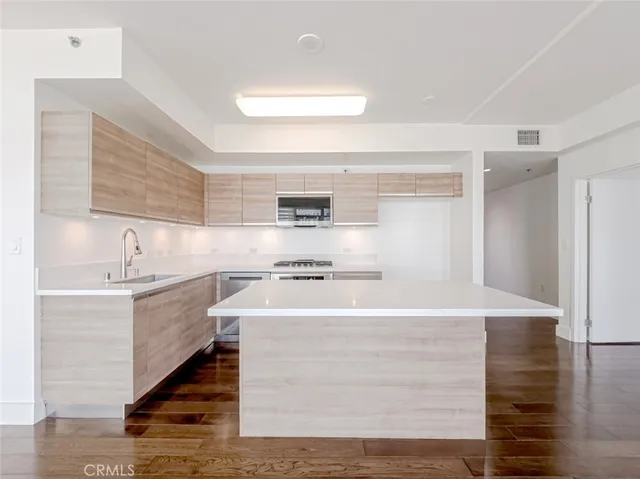 a kitchen with a stove window and cabinets