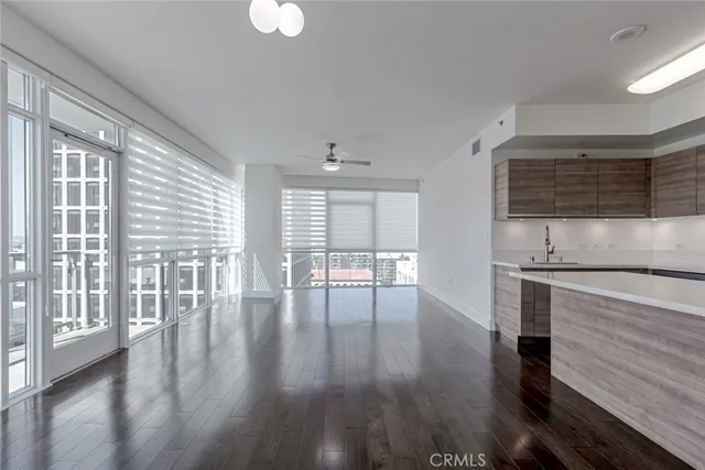 a view of a kitchen with wooden floor and outdoor space