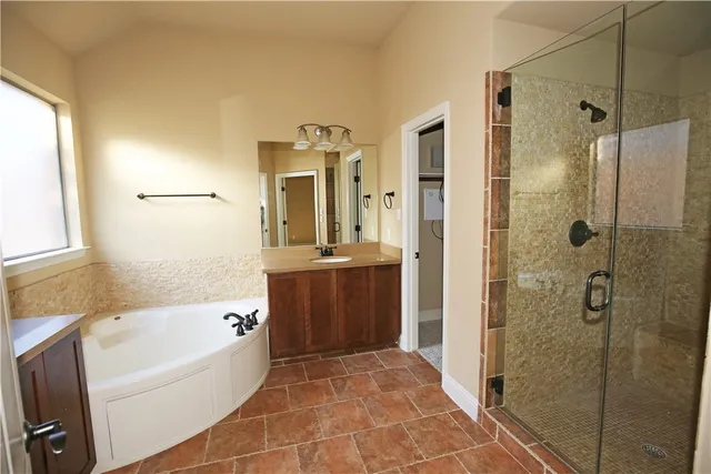 a bathroom with a bathtub and shower