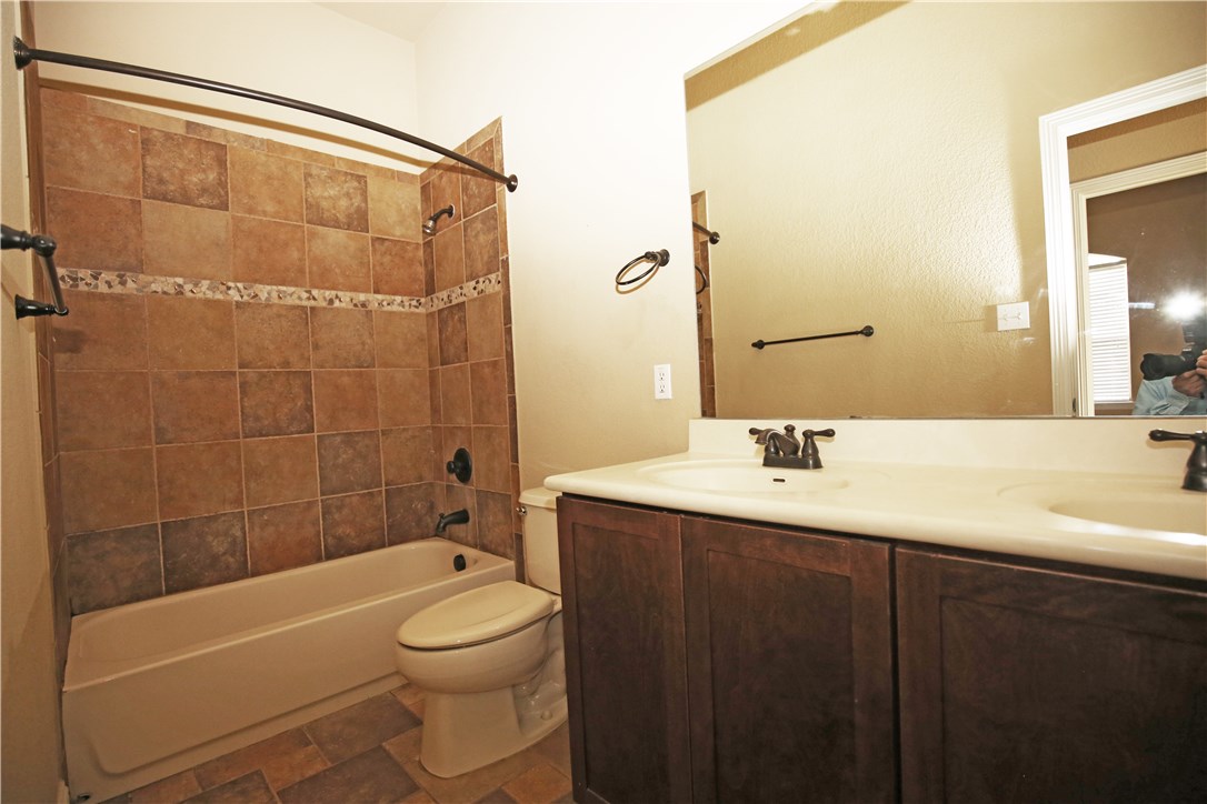 3921 Sapphire Loop Round Rock, TX 78681 - Photo 20 of 24 a bathroom with a sink a toilet and shower