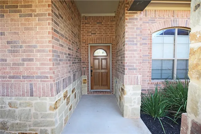 a view of entryway with a brick wall