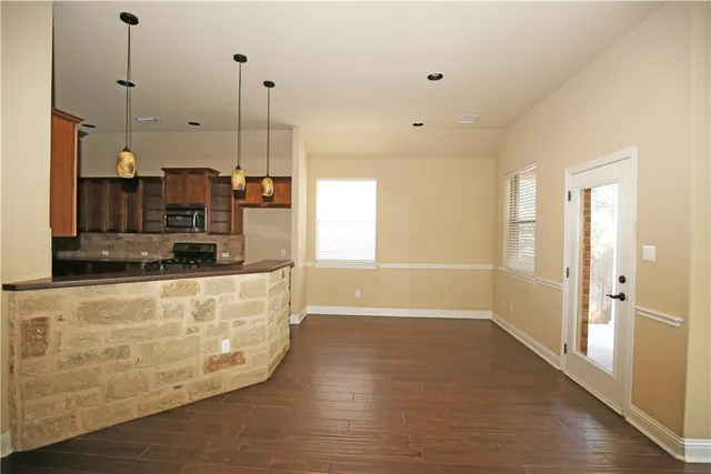 a view of a kitchen with a sink and dishwasher wooden floors