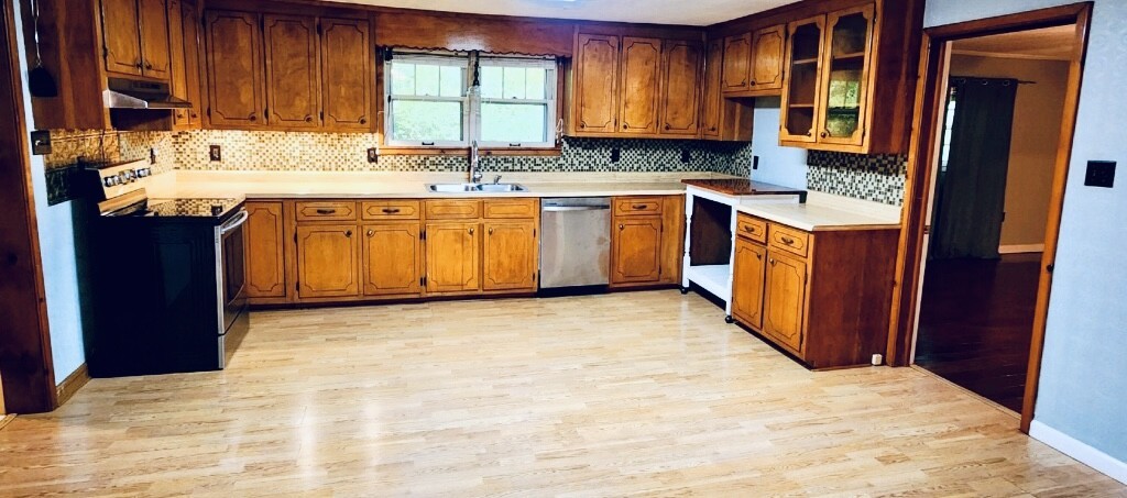 701 Littrell Road Loretto, TN 38469 - Photo 12 of 22 a kitchen with stainless steel appliances granite countertop a sink stove and cabinets