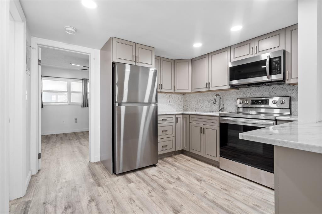1110 North Riverside Drive, Unit 20 Pompano Beach, FL 33062 - Photo 13 of 32 a kitchen with appliances a sink and a refrigerator