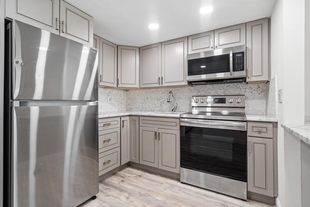1110 North Riverside Drive, Unit 20 Pompano Beach, FL 33062 - Photo 15 of 32 a kitchen with stainless steel appliances a stove microwave and refrigerator
