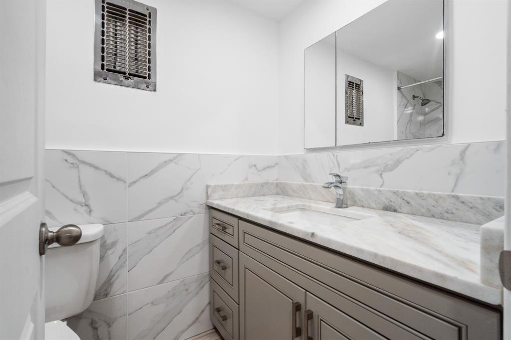 1110 North Riverside Drive, Unit 20 Pompano Beach, FL 33062 - Photo 16 of 32 a bathroom with a granite countertop sink and a mirror