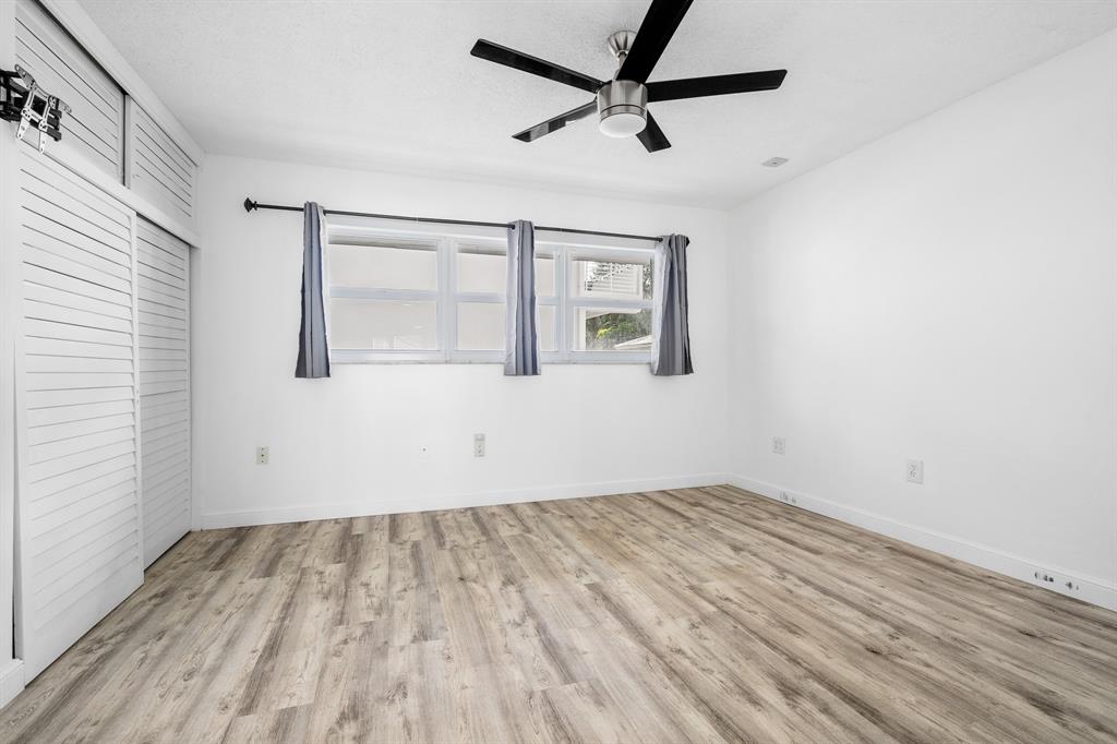 1110 North Riverside Drive, Unit 20 Pompano Beach, FL 33062 - Photo 18 of 32 an empty room with a window and a ceiling fan