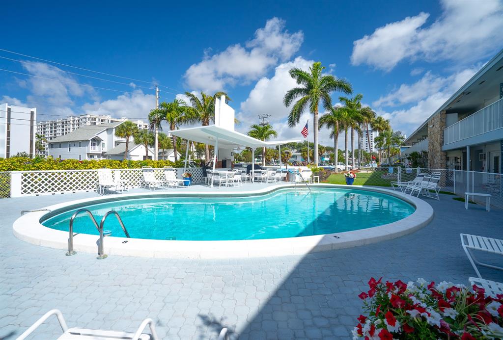 1110 North Riverside Drive, Unit 20 Pompano Beach, FL 33062 - Photo 6 of 32 a view of a swimming pool with an outdoor seating