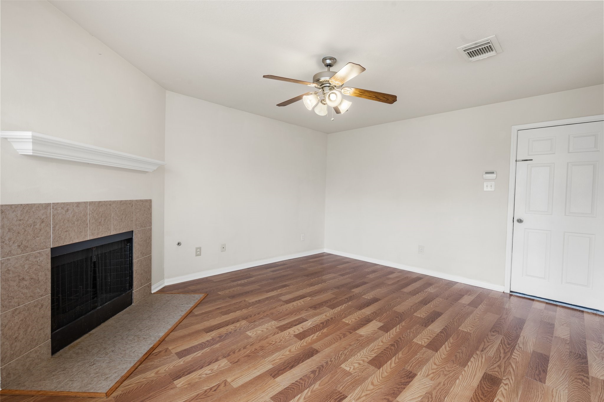 3111 Holly Ranch Drive Katy, TX 77494 - Photo 17 of 28 wooden floor in an empty room with a fireplace