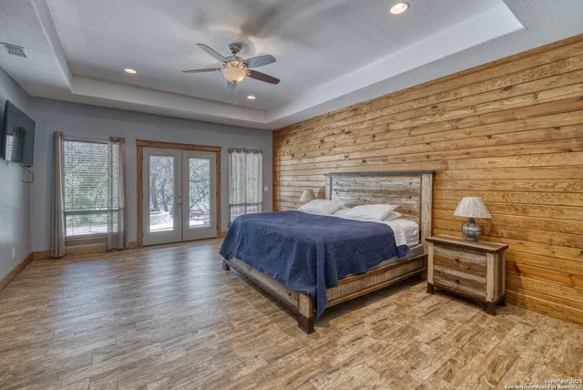 a spacious bedroom with a bed and a chandelier