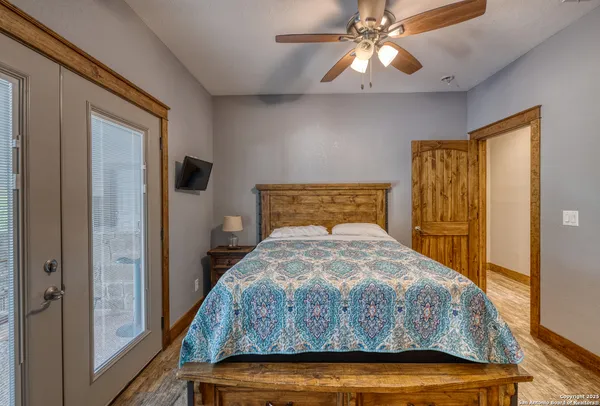 a bedroom with a bed and a chandelier