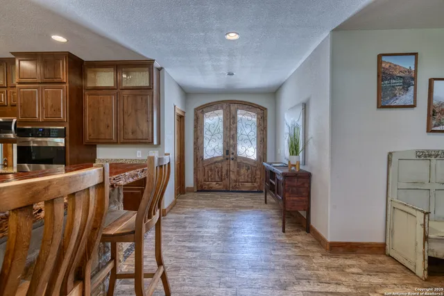 a view of a a dining room with furniture window and wooden floor