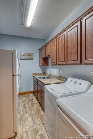 a kitchen with a refrigerator and a stove top oven