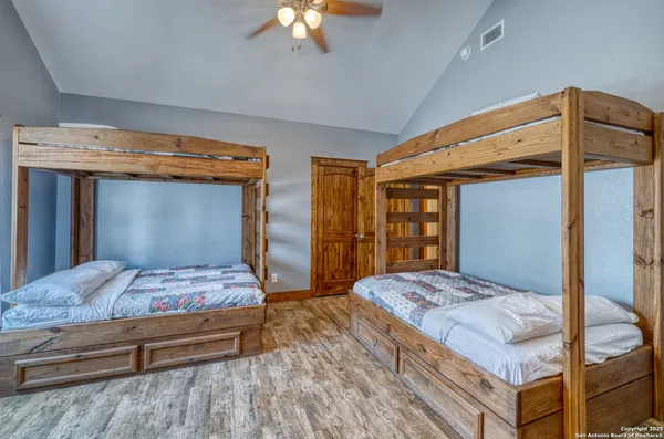 a bedroom with a large bed and a chandelier