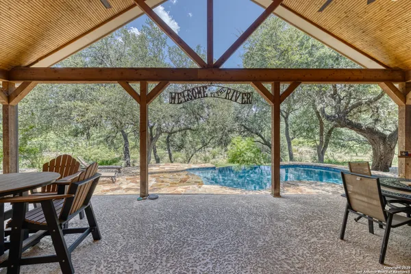 a view of a porch with chairs and backyard