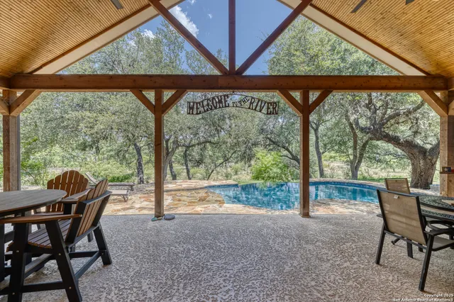 a view of a porch with chairs and backyard