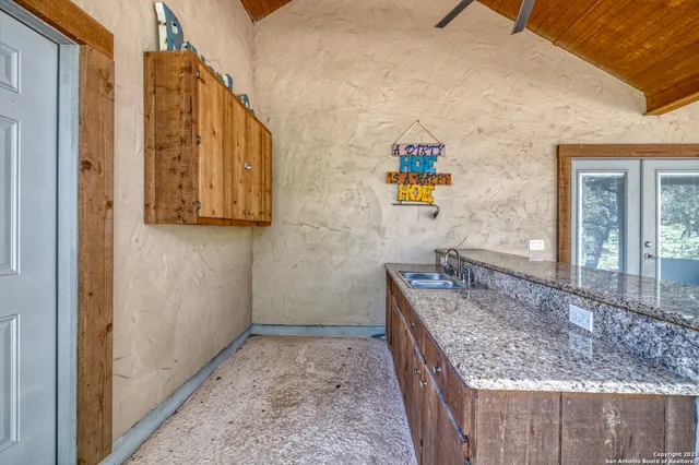 a view of backyard with swimming pool and sitting space