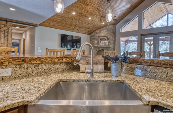 a kitchen with granite countertop a sink and a counter top space