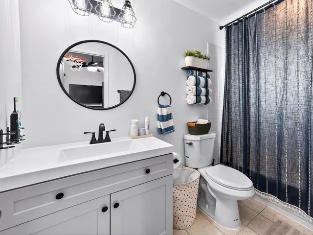 a bathroom with a toilet a sink and a mirror