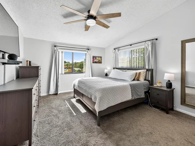 a bedroom with a bed dresser and a window