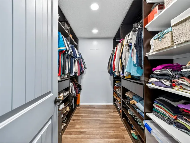 a view of a closet with storage and utility room