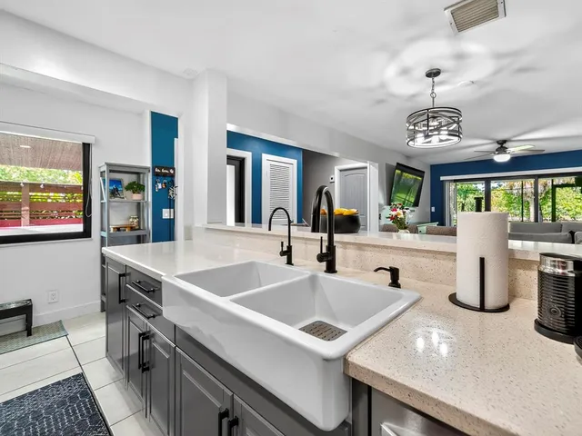 a kitchen with a sink and living room