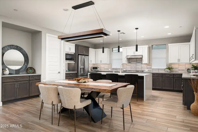 a living room with furniture and view of kitchen