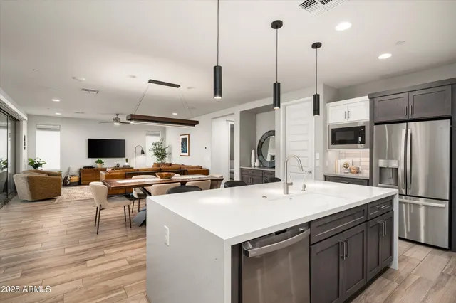 a kitchen with stainless steel appliances a sink stove and refrigerator