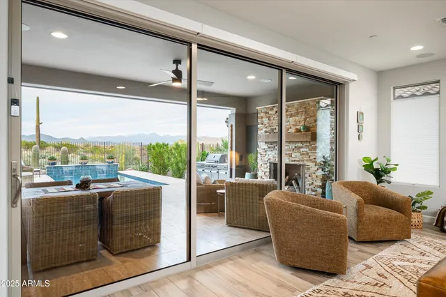 a living room with furniture and a floor to ceiling window