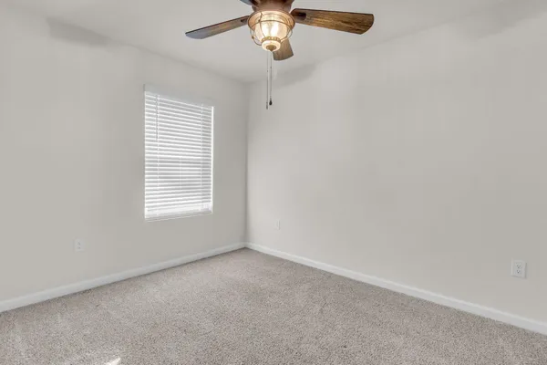 a view of room with window and ceiling fan