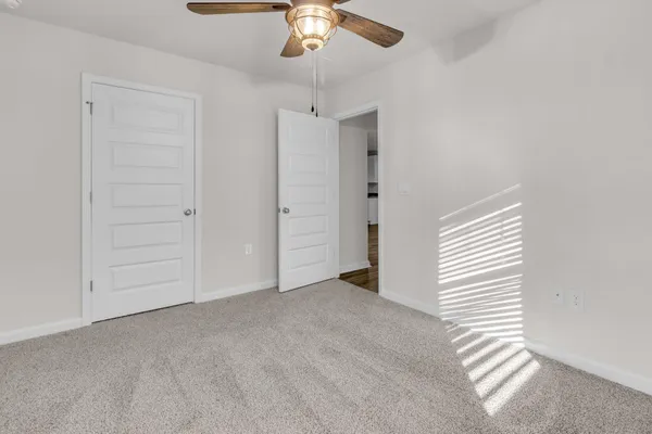 an empty room with a ceiling fan