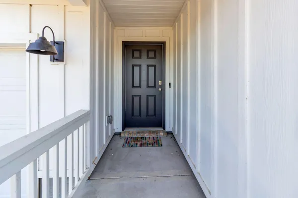 a view of a hallway with wooden floor and stairs