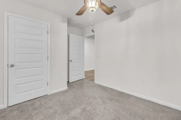 an empty room with a ceiling fan