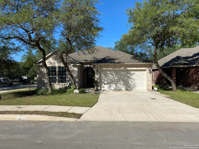 a front view of a house with a yard and a garage