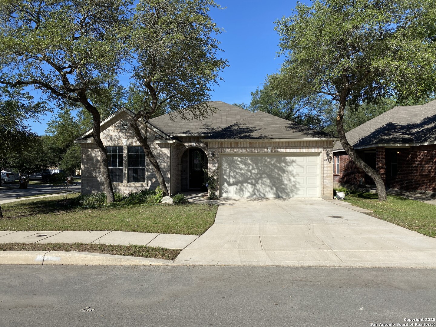 a front view of a house with a yard and a garage