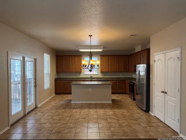 a kitchen with a refrigerator and microwave