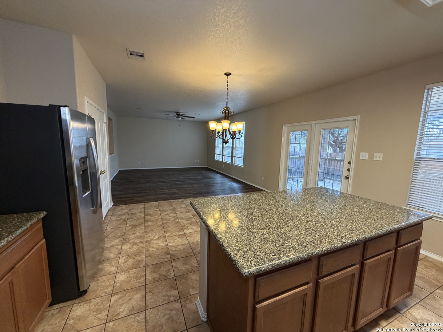 20803 Foothill Pine San Antonio, TX 78259 - Photo 3 of 9 a kitchen with kitchen island a counter top space and a refrigerator